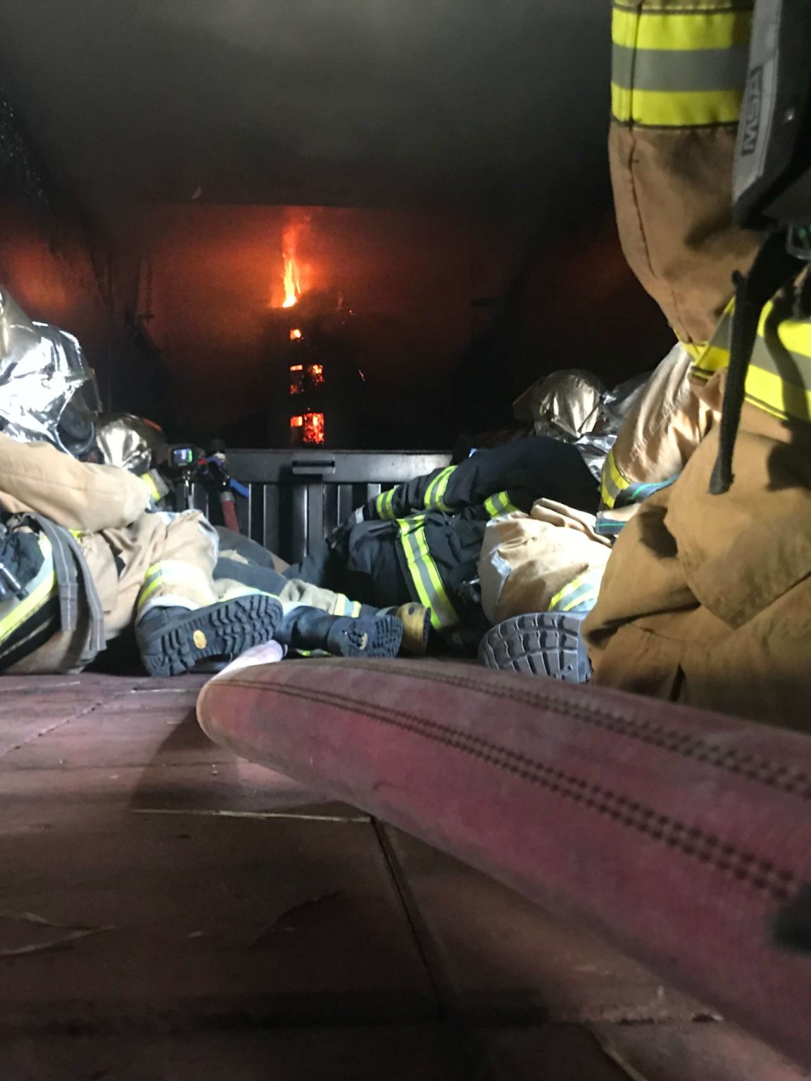 Firefighters wearing Protective Silver Helmet Covers