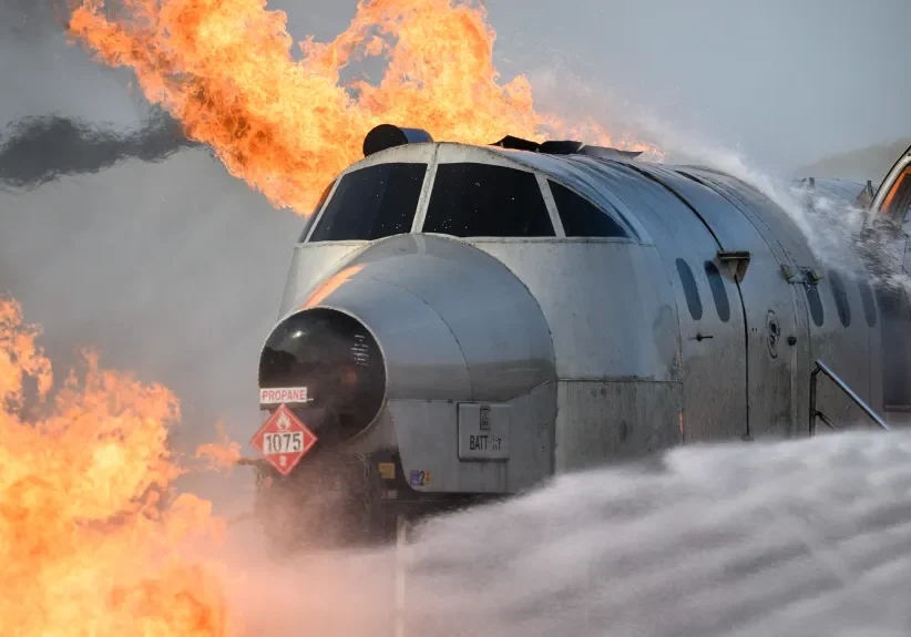 Propane-fueled flames soared at a simulated plane crash, at one point spiraling into a firenado. A fire crew from the nearby airport arrived first, spraying foam on the flames.